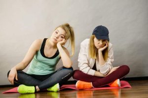 two-attractive-women-wearing-sports-clothes-sitting-exercise-mat-being-bored-tired-hard-workout-two-sporty-women-being-140295591.jpg